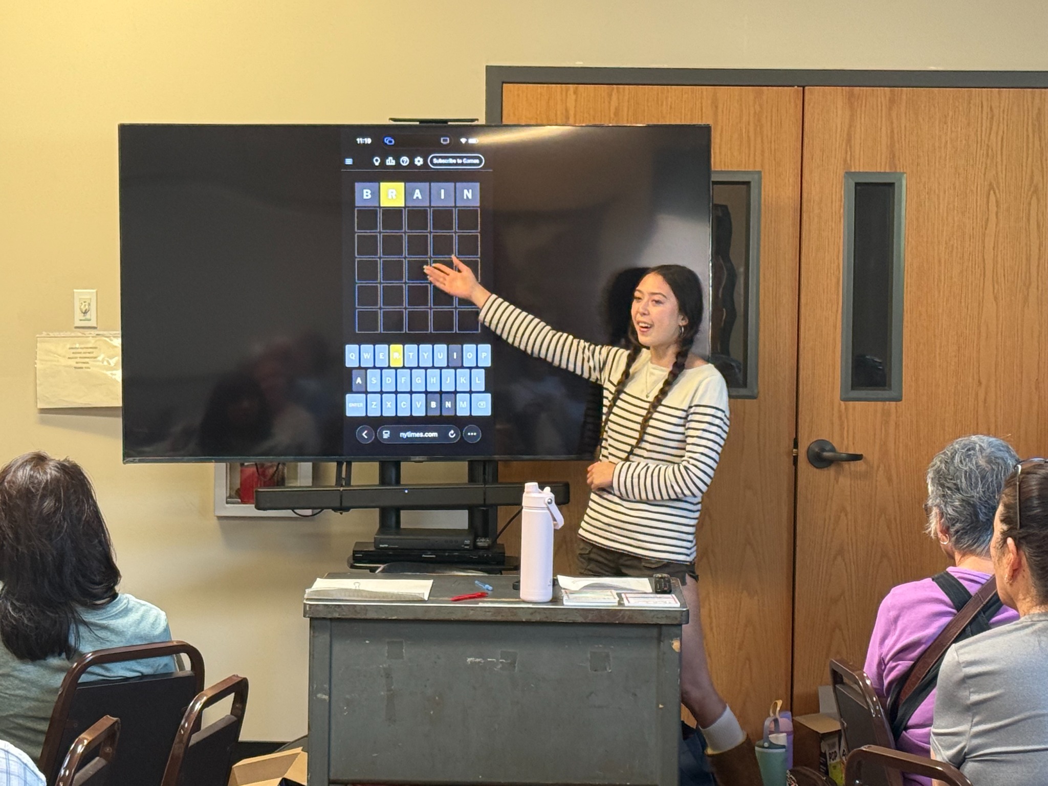 Alia demonstrating a brain game on a large screen